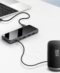 Sleek Usb C Docking Station For Triple Monitors With Usb 3.0 Ports And Dual Card Slots In Heavy Duty Aluminum Build connected to laptop.