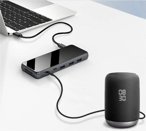 Sleek Usb C Docking Station For Triple Monitors With Usb 3.0 Ports And Dual Card Slots In Heavy Duty Aluminum Build connected to laptop.
