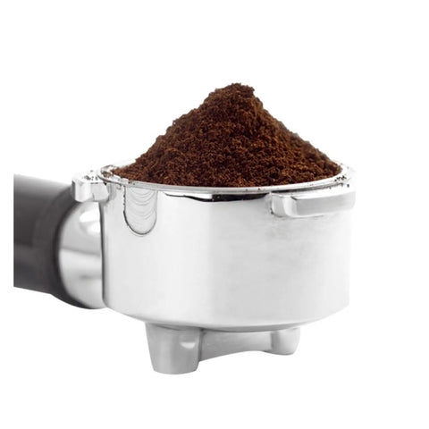 Electric Milk Frother For Cappuccino And Latte Brewing Stainless Steel Coffee Steamer with coffee grounds in a metallic portafilter.