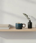 Gotta Love This Ceramic Espresso Cup With A Natural Wood Handle Kickin Up Your Daily Brew Routine While Keeping Things Cool To Touch And Looking Sharp On Any Counter Space on a wooden shelf.
