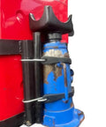 Close-up of Bottle Jack Axle Saddle Adapter for 2 Inch and 3 Inch Axle Tubes, heavy-duty steel construction, attached to a red jack