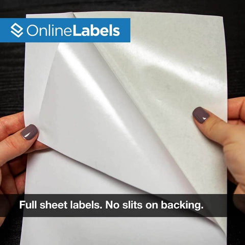 Full-sheet white matte label paper (8.5 x 11 in) being peeled from backing; OnlineLabels branding visible.