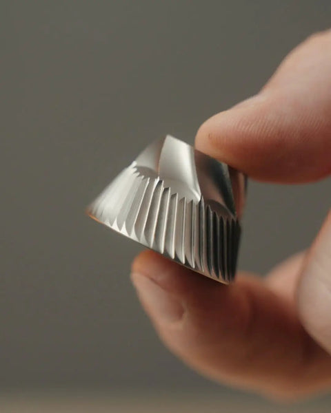 Close-up of 40mm stainless steel conical burr from Dope Stepless Coffee Grinder for precise espresso grinding.
