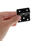 Hand holding Black Iron Box Folding Hinges Set, 20 Pieces, Three-Fold Straight Corner Design with Six-Hole Mount for wooden boxes.