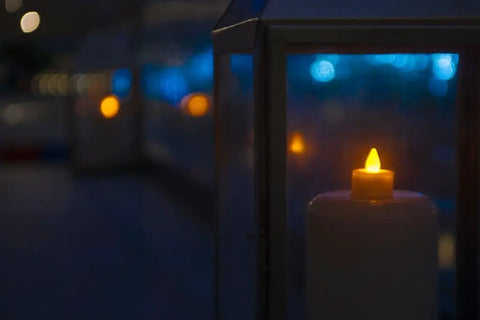 Wireless Inductively Rechargeable Flameless LED Tealight Candles Replacements 12 Pack Warm White glowing in lanterns at night