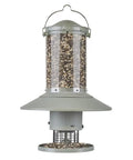 Programmable Automatic Bird Feeder Built Tough Outdoors With Darn Near Squirrel Proof Guard Weather Resistant Body Large Capacity Battery Powered Avian Dish Hassle Free Setup Classic Green cylindrical seed container with metal base.