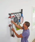 Person organizing tools on FastTrack Garage Hook Kit And Tool Organizer With All In One Rail For Wall Shed And Garden Storage 6 Piece Heavy Duty Hooks Movable With Locking Grippers