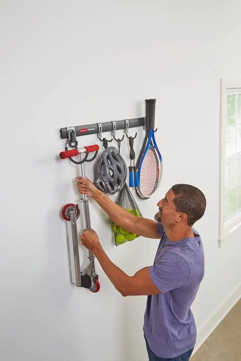 Person organizing tools on FastTrack Garage Hook Kit And Tool Organizer With All In One Rail For Wall Shed And Garden Storage 6 Piece Heavy Duty Hooks Movable With Locking Grippers