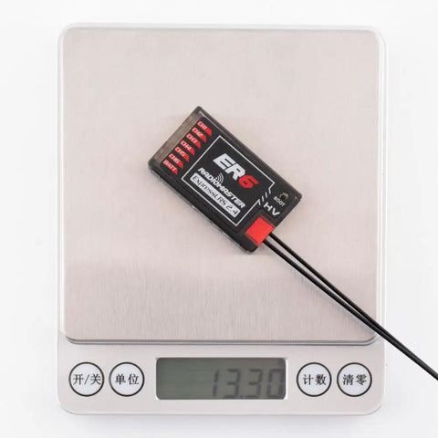 ExpressLRS 2.4GHz 6 Channel PWM Receiver for FPV Drones, Airplanes and Gliders on digital scale showing weight.