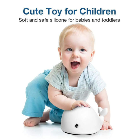 Baby playing with Cute Whale Night Light For Kids With 7 Color Changing LEDs, Tap Control Silicone Baby Night Lamp, BPA Free