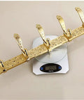 Sleek European Style Golden Coat Hook For Bathroom And Entryway Built Tough Wall Hanging Clothes Rail With Smooth Carved Details Premium Wall Mount and Real Deal Storage Setup on a scale.