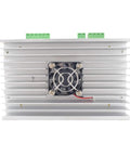 Stepper motor driver module on silver aluminum heatsink with cooling fan and green terminal blocks.