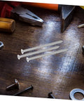 Stainless Steel Countersunk Flat Head Self Tapping Screws For Furniture Assembly on a wooden table with tools
