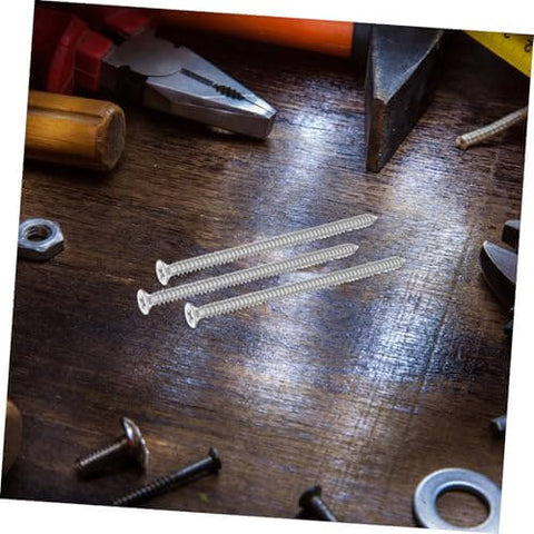 Stainless Steel Countersunk Flat Head Self Tapping Screws For Furniture Assembly on a wooden table with tools
