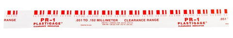 Close-up view of red PR-1 Plastigage strip used in Pro-Grade Plastigauge Kit For Bearing Clearance, Color-Coded Sizing, Oil-Soluble Formula.