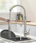 Kitchen Faucet with Pull Down Sprayer, Commercial Spring Single Handle Stainless Steel Sink Faucet in action at a kitchen sink.