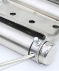 Close-up of a stainless steel spring hinge for two-way doors with free entry and exit, double-sided, showing adjustable closing mechanism.