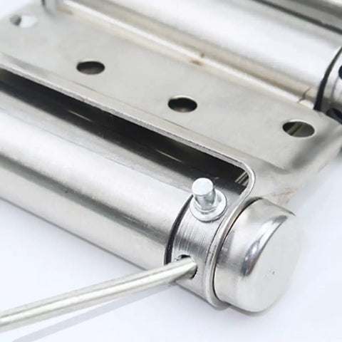 Close-up of a stainless steel spring hinge for two-way doors with free entry and exit, double-sided, showing adjustable closing mechanism.