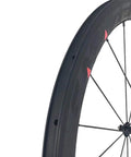 Close-up of 50mm deep carbon rim with basalt brake surface, part of the Carbon Road Bicycle Wheelset Clincher 50mm Deep Rim Basalt Brake Surface 3K Weave