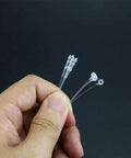3000 Piece Hella Tough 3 Inch Clear Security Loop Snap Lock Fasteners For Apparel Retail Tags No Label Gun Required Hand Install Durable Garment Tether Cords held in hand.
