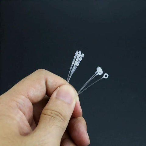 3000 Piece Hella Tough 3 Inch Clear Security Loop Snap Lock Fasteners For Apparel Retail Tags No Label Gun Required Hand Install Durable Garment Tether Cords held in hand.