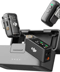 Wireless Lavalier Mic Kit With 2 Transmitters And 1 Receiver Charging Case Noise Canceling 820 Ft Range Plug And Play For iPhone Android And Cameras Bundle With 2 Omnidirectional Condenser Lavalier Mics viewed from above showing charging case with OLED display and two transmitters.