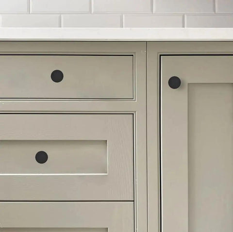 Matte Black Round Cabinet Knobs Ten Pack One And One Fifth Inch Lead Free Safe Drawer Pulls on kitchen cabinets.