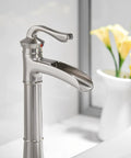 Vessel Sink Faucet With Waterfall Style In Brushed Nickel, Tall Farmhouse Style Bathroom Faucet, side view near flowers