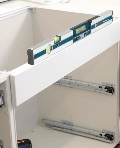 GIM 60 24 Inch Digital Level with Illuminated Rotating Display on white cabinet for angle readings