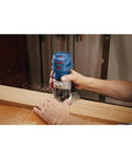 Person using Colt 1.25 HP Variable Speed Palm Router With 7 Amp Motor Precision Handheld Router for woodworking detail work.