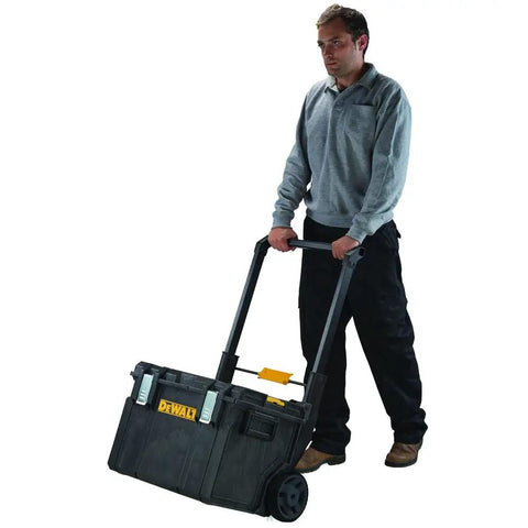 Man using Rugged ToughSystem Tool Box With Pull Back Lid For Maximum Storage Non Detachable Lid Wide Grip Handle on wheels