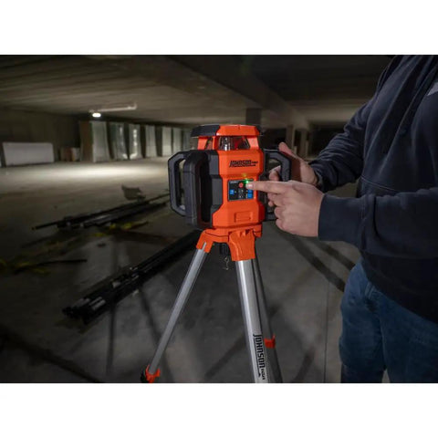 Jobsite Ready Self Leveling Red Dual Slope Rotary Laser System With 4,000 Ft Range IP67 on tripod in construction site