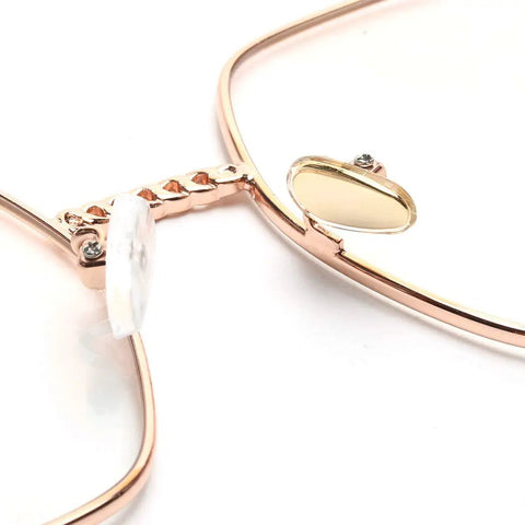 Close-up of gold metal glasses frame with a soft silicone airbag nose pad, part of Super Comfy Silicone Airbag Glasses Nose Pads.