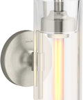 Purist 1 Light Sconce With Rounded Glass Shade And Tubular Metal Base, Brushed Nickel finish, side view with lit bulb