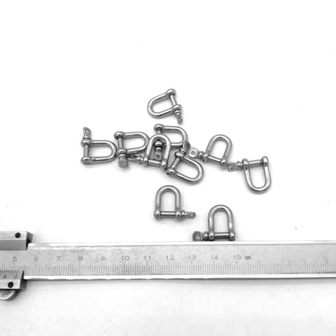 316 Stainless Steel D Shackle Mini Shackles For Paracord Jewelry And Bracelet Hardware Built Tough Marine Grade Rigging 1 Eighth Inch Pin Opening Durable Pack Of 10 For Survival Gear And Craft Projects with ruler for scale.