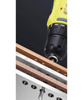 Heavy Duty Cordless Electric Drill With Rechargeable Battery And Brushless Motor Smart Chuck drilling into wood on a work surface.