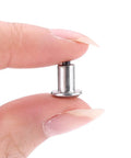 Heavy Duty Tungsten Steel Tire Stud Screws 100 Piece Set shown being held in hand for easy installation on winter tires.
