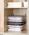 Slick Setup Folding Clothes Organizer Set For Quick T Shirt Folder Board With Stackable Clothing Dividers in closet with neatly folded clothes.