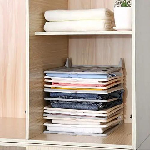 Slick Setup Folding Clothes Organizer Set For Quick T Shirt Folder Board With Stackable Clothing Dividers in closet with neatly folded clothes.