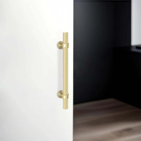 Top Shelf Brushed Gold Kitchen Cabinet Handles Five Inch Pulls on a white cabinet door, solid zinc alloy, modern design.