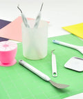 Vinyl Weeding Tools Set for Crafting and Diy Projects on green mat, featuring hook, weeder, scissors, and scraper with colorful background.