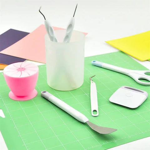 Vinyl Weeding Tools Set for Crafting and Diy Projects on green mat, featuring hook, weeder, scissors, and scraper with colorful background.