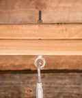 Three Eighth Inch Galvanized Eye Bolt Forged Steel Industrial Fastener Corrosion Resistant Outdoor Anchor secured to wood beam.