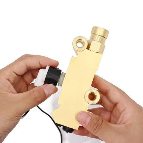 Universal Brake Proportioning Valve Wire Sensor And Wiring Harness Compatible With Pv2 Pv4 Pv6 Systems held in hand, golden finish.