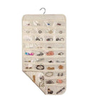 Double Sided Hanging Jewelry Organizer Bag With Eighty Clear Storage Pockets For Earrings Necklaces And Brooches, showing clear pockets filled with jewelry.