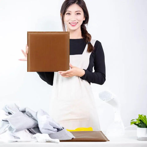 Person holding a brown cushion from the Heat Press Pillow Set 9 Pieces In 1 with fabrics and tools on table