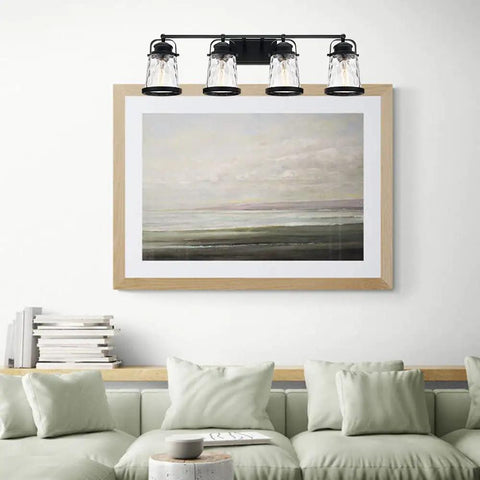 Four Light Farmhouse Vanity Lights With Rustic Wall Sconces And Hammered Glass Shades above a couch and artwork in a living room.