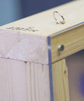Fish Ball Chain 16 Feet With 2 Stop Rings installed in wooden frame, close-up of ring for hidden wiring in narrow spaces