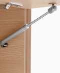 Slick Soft Close Gas Struts For Cabinets And Toy Boxes With Dead Sure Lifting Action Premium Safety Lift Supports, installed on wood cabinet.