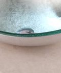 Close-up of Dope Sleek Oval Glass Vessel Sink and Waterfall Faucet Combo With Pop Up Drain showing glossy tempered glass finish.